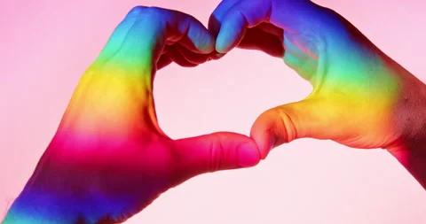 Heart Gesture with Two Hands in Rainbow Light over Pink Background Stock Footage 347956691