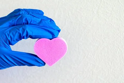 Heart in the hand light background. Stock Photos