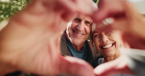 Heart hands, happy and face of old couple outdoor for romantic connection, 動画素材 338187765