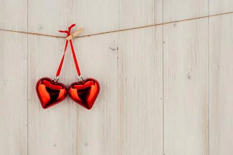 Heart hanging on the clothesline. On old wood background 库存照片