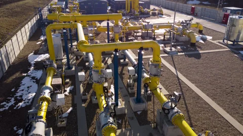 Heart of industrial complex network yellow pipes crisscrosses landscape carrying Stock Footage 274849480