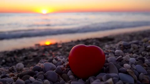 The heart lies on the beach with pebbles at sunset. Stock Footage 161805904