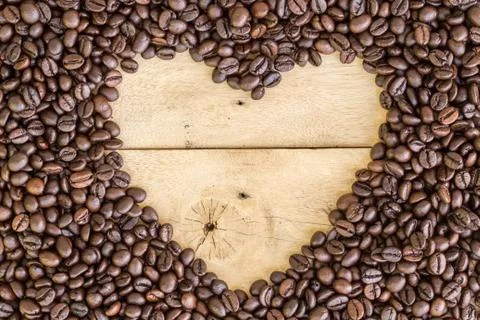 Heart love space for sample text of coffee beans on wood Stock Photos