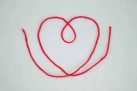 Heart made of red thread on a white background. Stock Photos