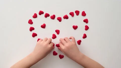Heart made of shiny red small decorative hearts on a white background with Video stock 169503536