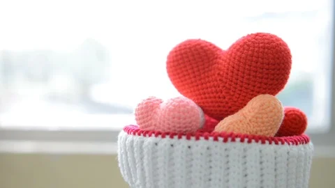 Heart made with a thread of a crocheted multicolored in knitting yarns hat. Stock Footage 107641884