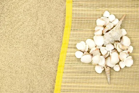 Heart made of white shells on straw lounger on sand with space for text Stock Photos