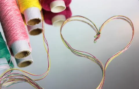 A heart of multicolored thread on the surface of the mirror. Heart shape thre Stock Photos