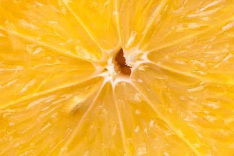 Heart of orange fruit extra close-up in a cut. Stock Photos