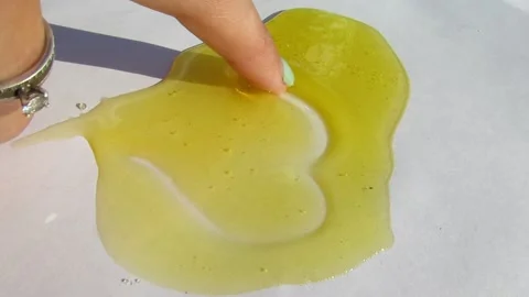 The heart is painted in a layer of honey Stock Footage 137158283