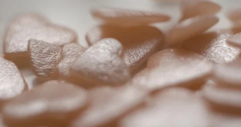 Heart pink decorative elements falling close up, studio 4K Video stock 263686723
