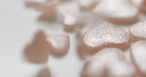 Heart pink decorative elements falling close up, studio 4K Video stock 263686753