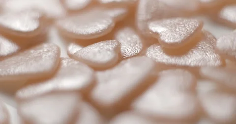 Heart pink decorative elements falling close up, studio 4K Stock Footage 263686871