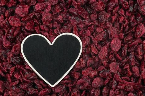 Heart pointer, the price tag lies on dried cranberry 写真素材