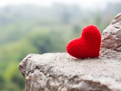 Heart put on stone The background is a forest and mountains. copy space for t Stock-Fotos