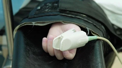 Heart Rate Sensor on the Arm of the Patient on the Operating Table under Stock Footage 70872998