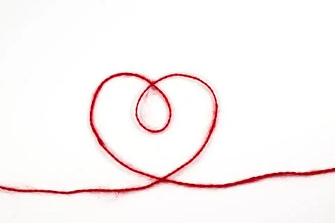 Heart from a red woolen thread on a white isolated background Stock Photos