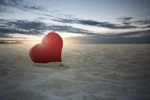 Heart on the sand with a dramatic sky background Stock Photos