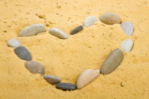 Heart into a sand Stock Photos