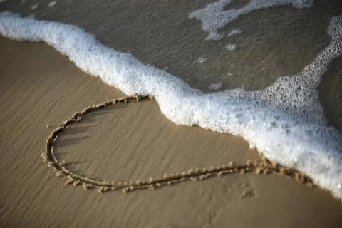 Heart on sand Stock Photos