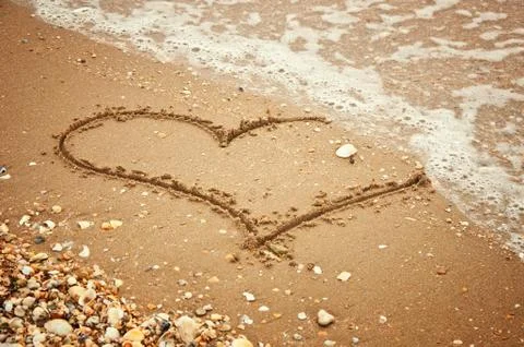 Heart on sand Stock Photos