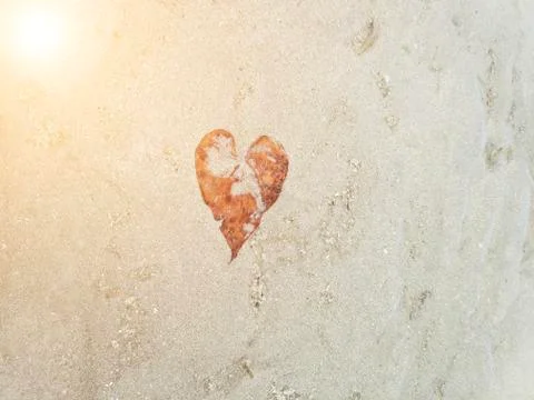 Heart on the sand under the sun Stock Photos