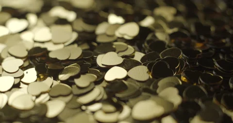 Heart sequins golden rotating close up, studio 4K Video stock 263687091