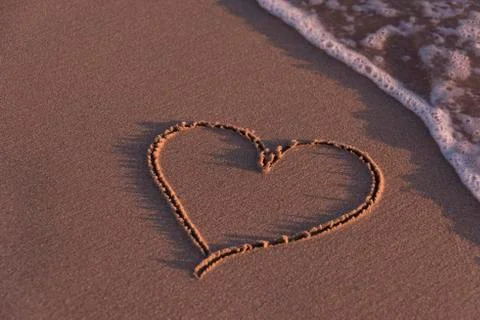 Heart shape on a beach Stock Photos