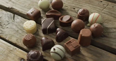 Heart shape black and white chocolates on wooden background at valentine's day Stock Footage 341942018