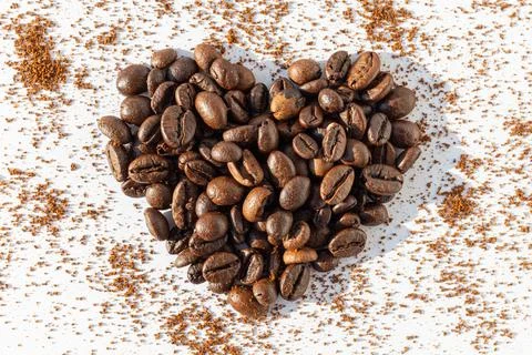 Heart shape from brown roasted coffee beans Robusta, Arabica coffee on a back Stock Illustration