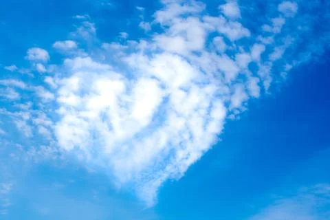 Heart shape clouds on a sunny day Stock Photos