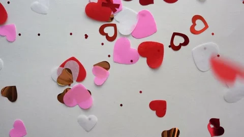 Heart shape confetti flying on the white background Stock Footage 167899400