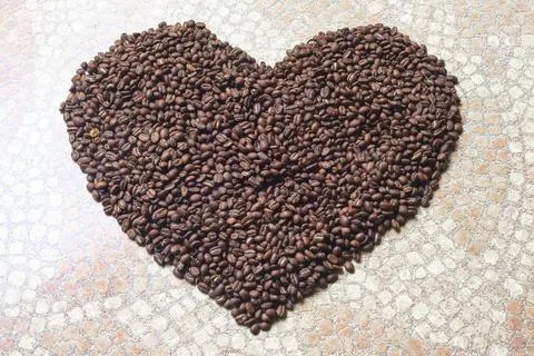 Heart shape created with roasted coffee grains Stock Photos