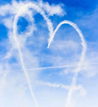 Heart shape with cupids arrow written in the sky with smoke Stock Photos