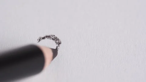 Heart shape from dark brown eye liner pencil on white background. Sketch dr.. Stock Footage 258916405