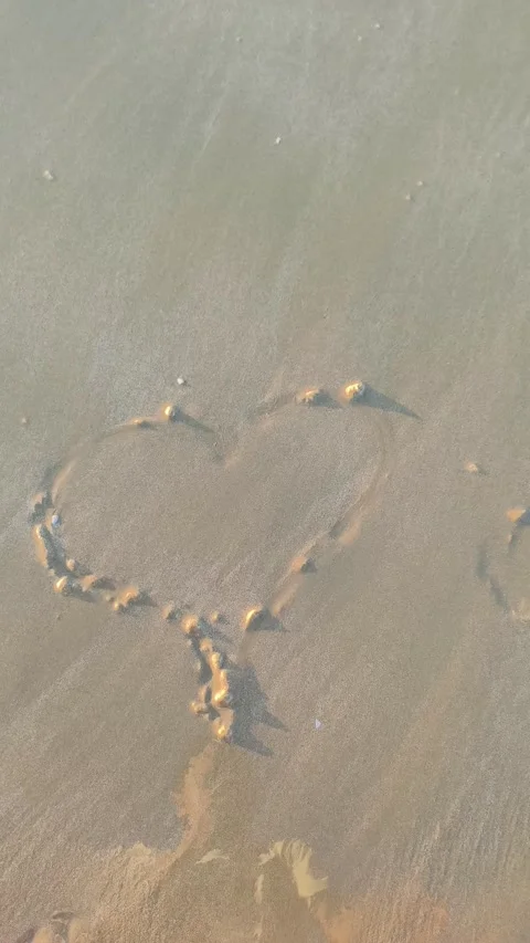 Heart Shape Drawn in Sand Washed Away by Ocean Wave Stock Footage 340381612