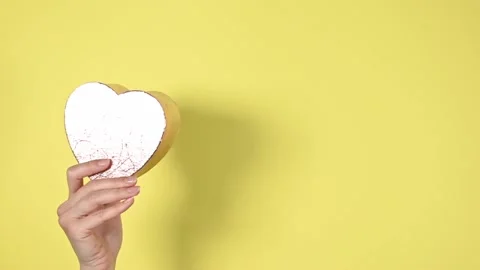 Heart shape gift box on yellow background. Stock Footage 147946497