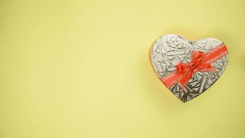 Heart shape gift box on yellow background. Stock Footage 147946553