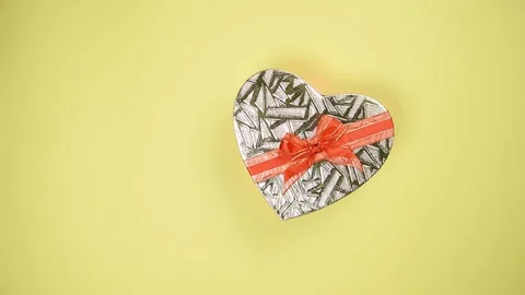 Heart shape gift box on yellow background. Stock Footage 147946571
