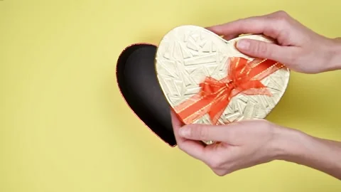 Heart shape gift box on yellow background. Stock Footage 147946582
