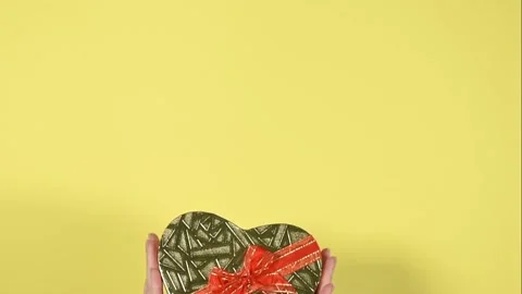 Heart shape gift box on yellow background. Stock Footage 147946664