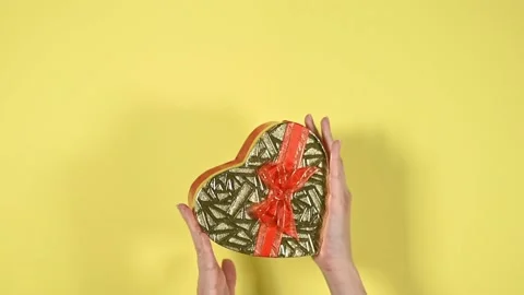 Heart shape gift box on yellow background. Stock Footage 147946755