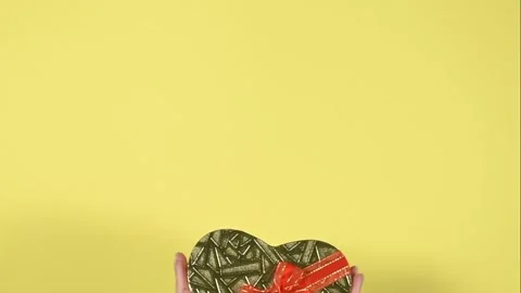 Heart shape gift box on yellow background. Stock Footage 147947451