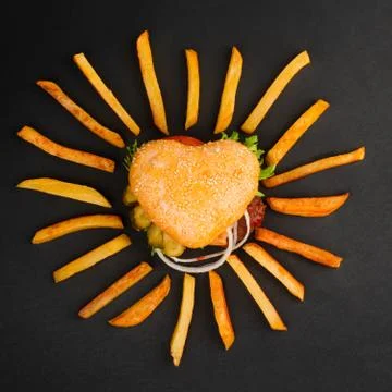 Heart shape hamburger on black Foto stock