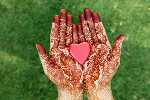 Heart shape in henna hands Stock Photos