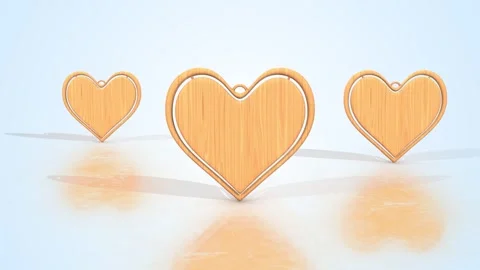 Heart Shape Keychains on a Reflective Floor. Wooden Textured Keychains. 4K Stock Footage 296748063