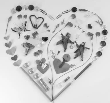 Heart shape lat design using office and art supplies, petals, butterfly, head Stock Photos