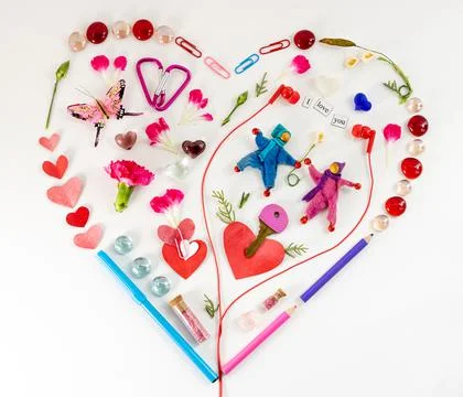 Heart shape lat design using office and art supplies, petals, butterfly, red Stock Photos