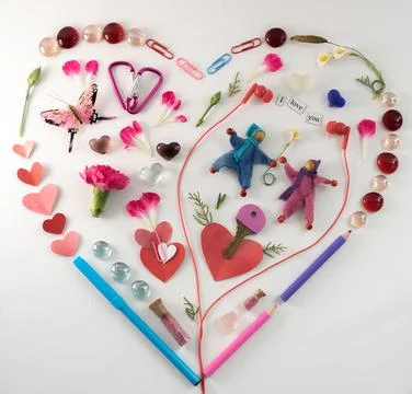 Heart shape lat design using office and art supplies, petals, butterfly, red Stock Photos