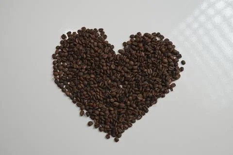 Heart shape made of coffee beans on white background 스톡 사진